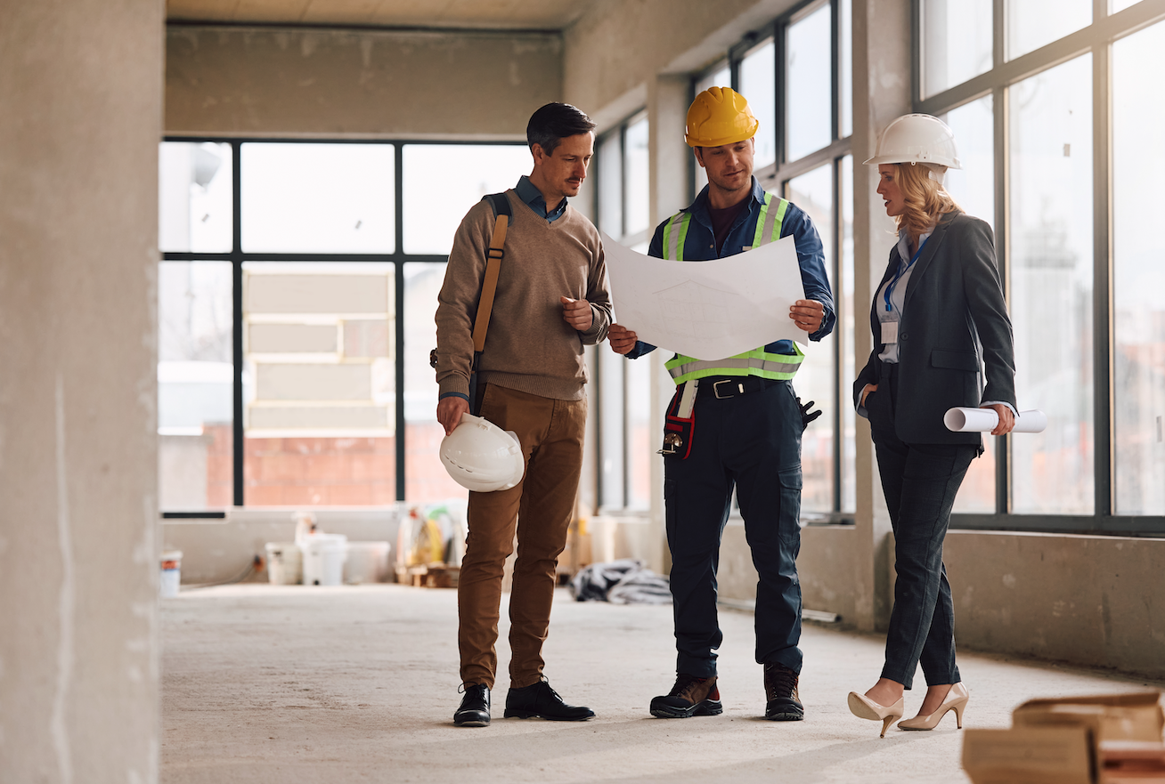 Yellow hard hat resting on legal documents